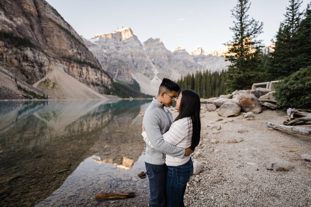 Couple faces one other during sunrise at Moraine Lake