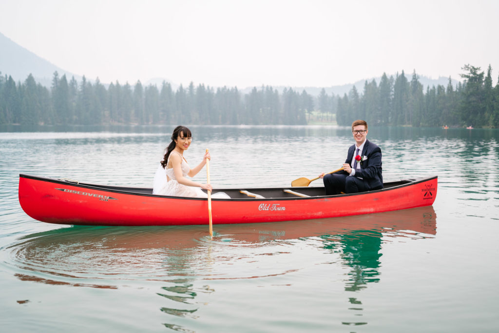 Bride and groom in a red canoe