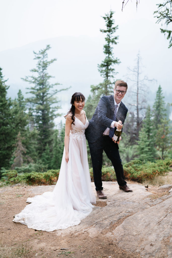 Groom pops champagne in Jasper National Park