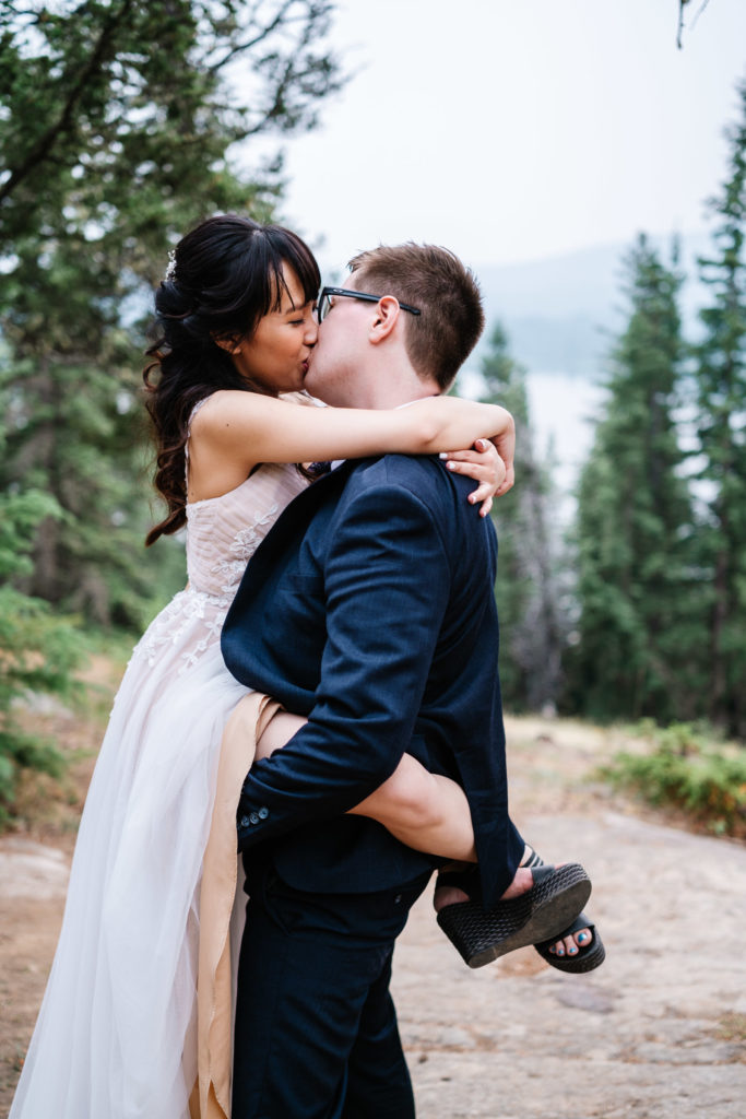Bride and groom kiss in Jasper National park