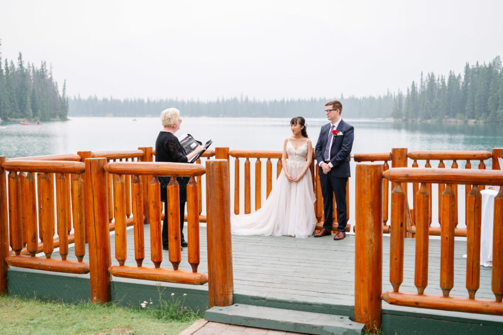 Couple stands on dock for their elopement in Jasper
