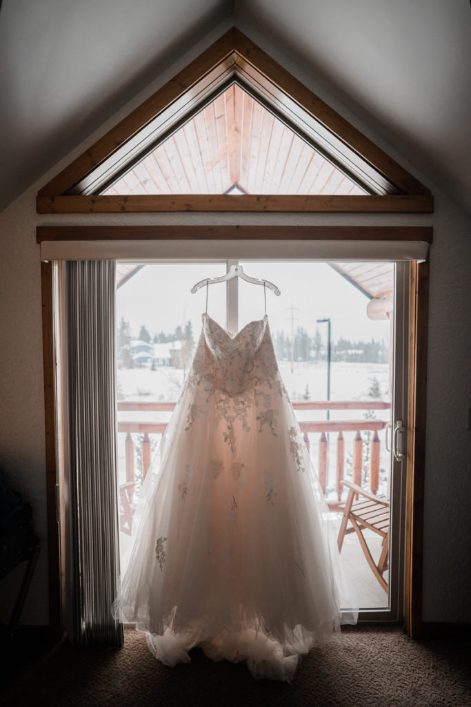 A wedding dress hangs in the window in Canmore Alberta. 