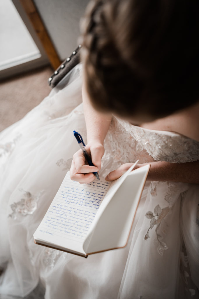 A bride sits in her room at A Bear and Bison Inn in Canmore writing in her custom vow book. 