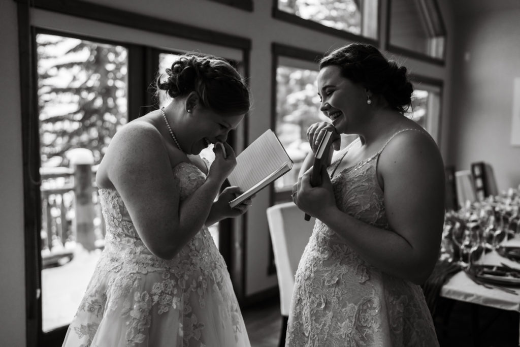Two brides are emotional reading personalized vows to each other. 