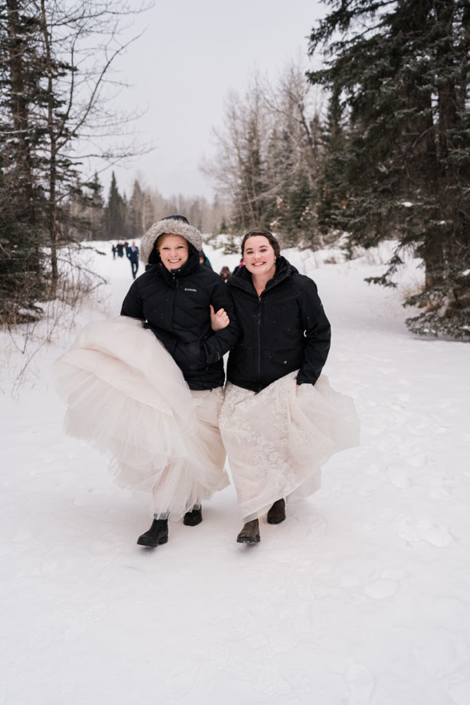 Two brides lead the way on snowy winter wedding in Canmore. 