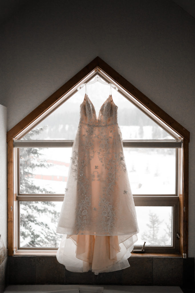 A wedding dress hangs in the window at A Bear and Bison Inn. 