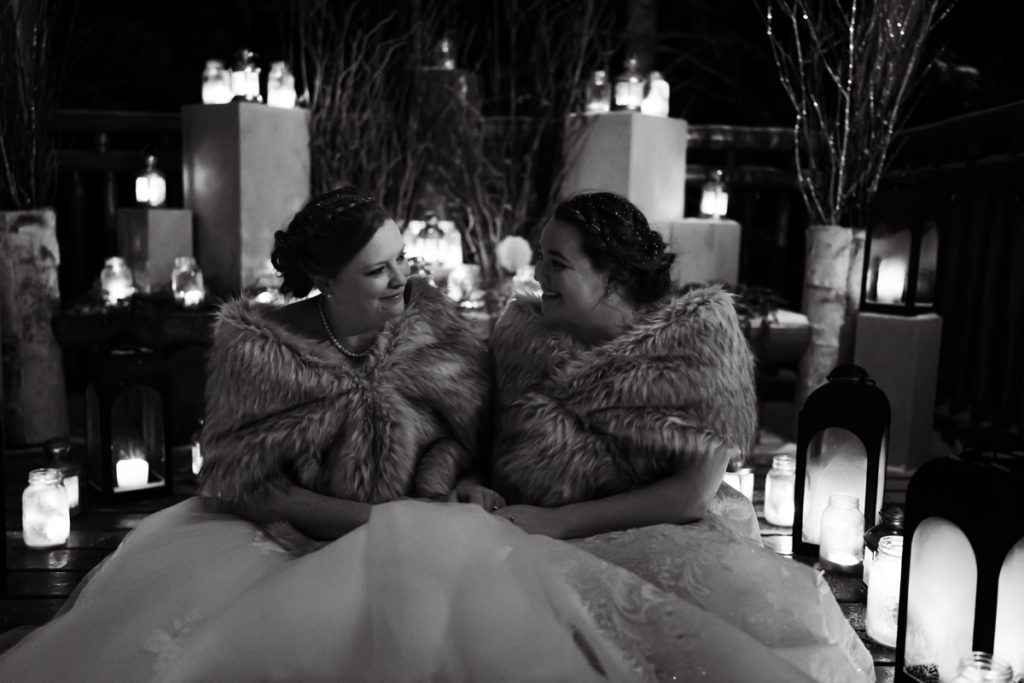 Black and white photo of brides in candle lit gazebo