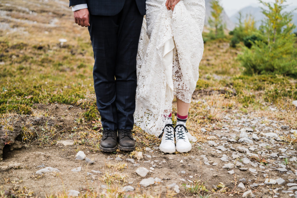 Bride and groom's feet wearing their hiking boots. 