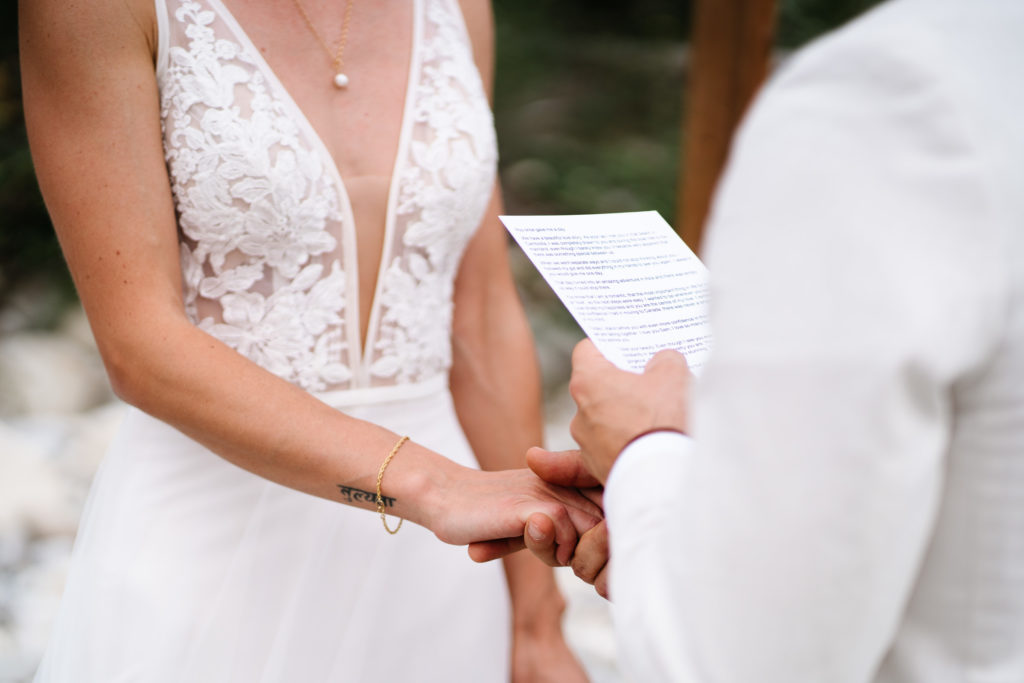 Close up of grooms vows during Jasper Intimate wedding ceremony.