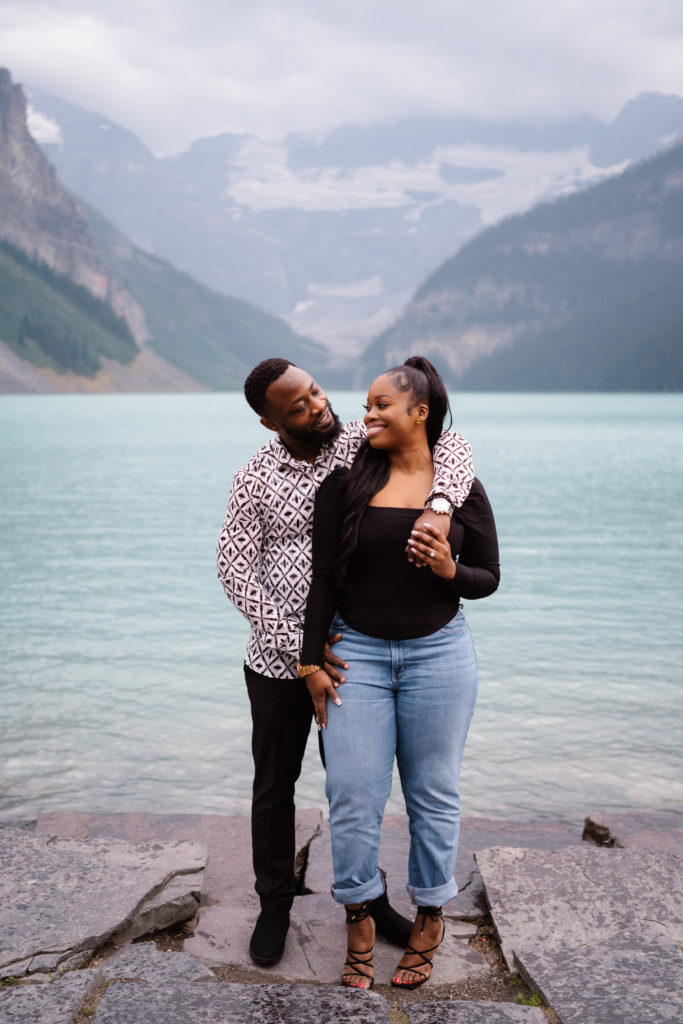 Couple poses in Lake Louise after surprise proposal.