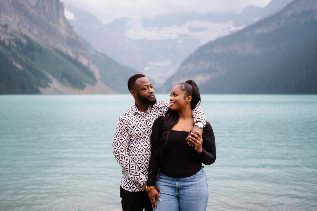 Couple looks into each others eyes after proposal in Banff National Park