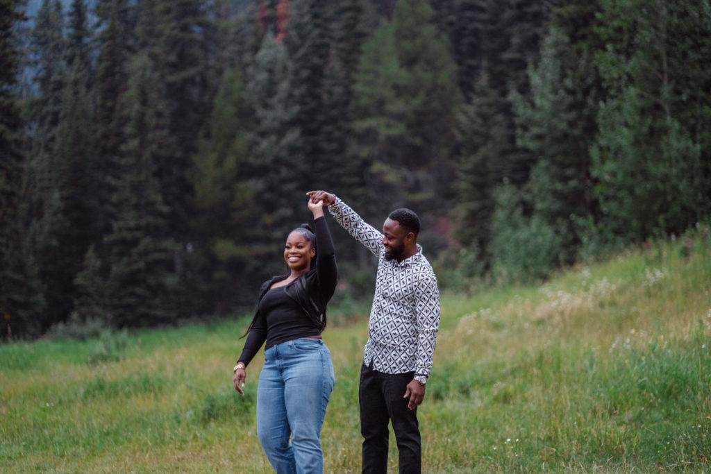 Newly engaged couple dance in Banff National Park