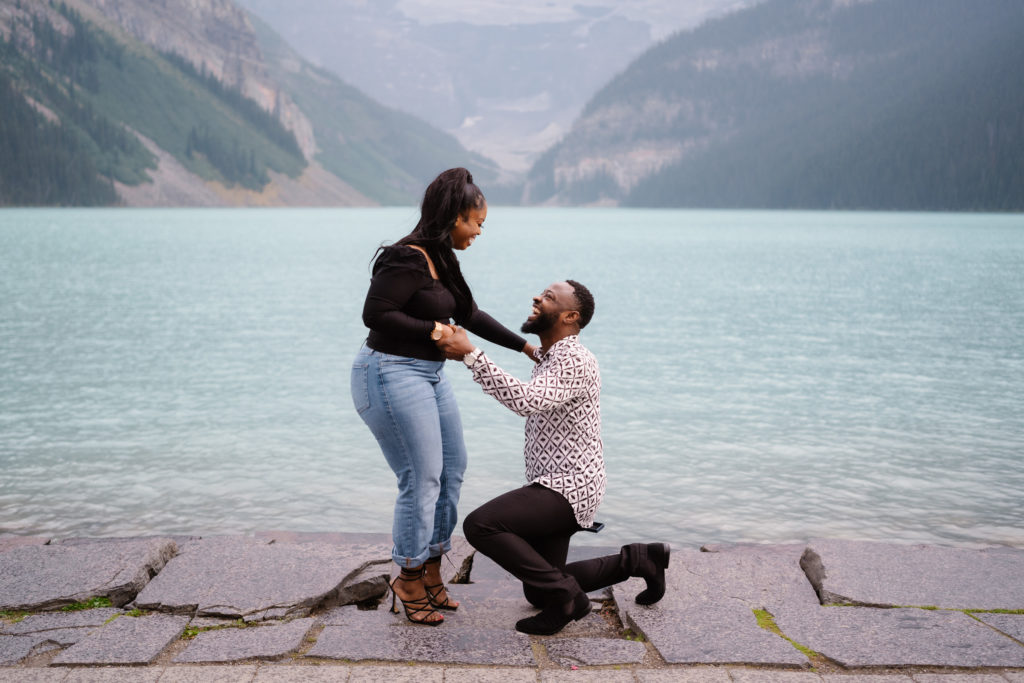 Man proposes at Lake Louise on warm summer evening