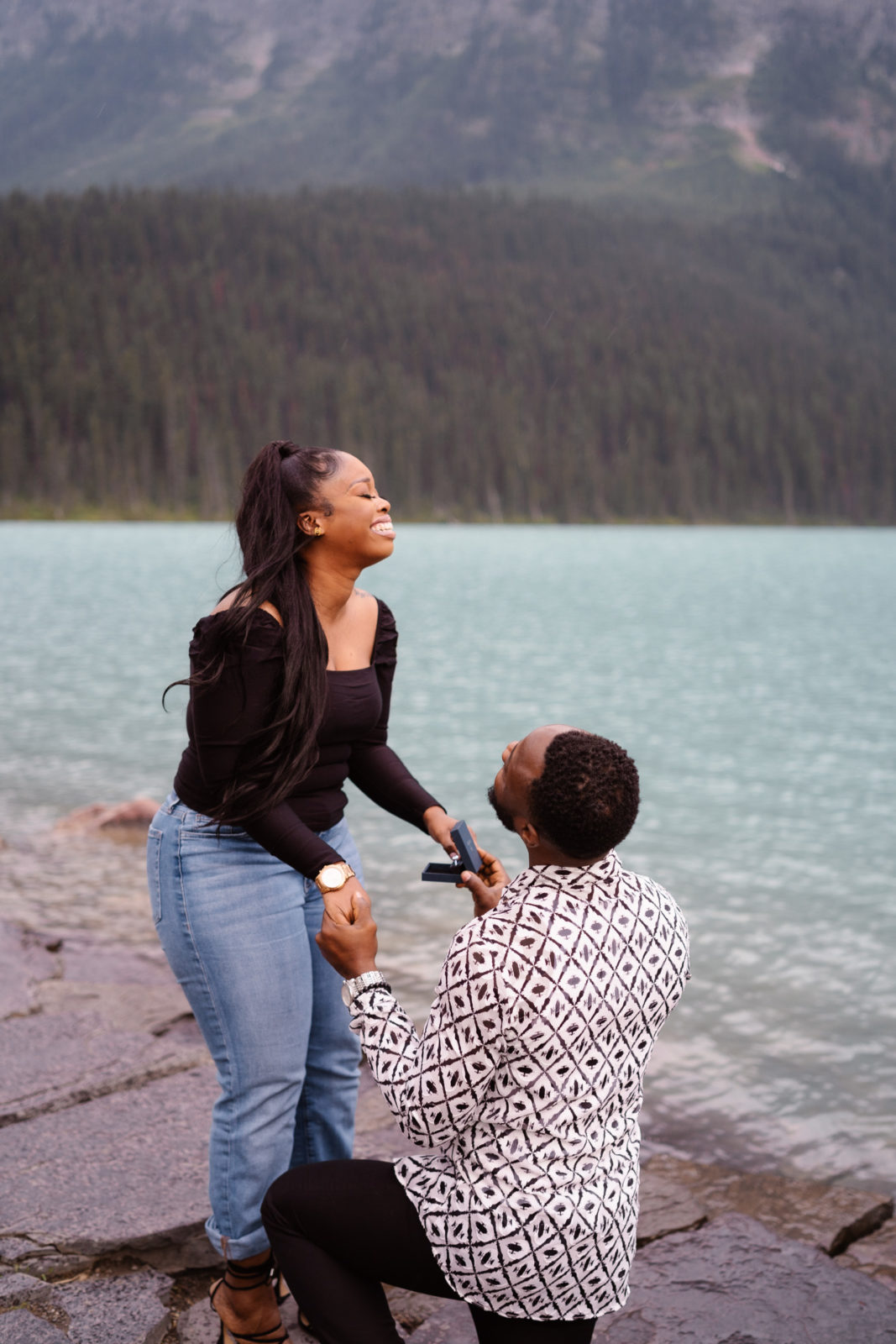 Man shows girlfriend ring and she is overcome with joy during Lake Louise Proposal.