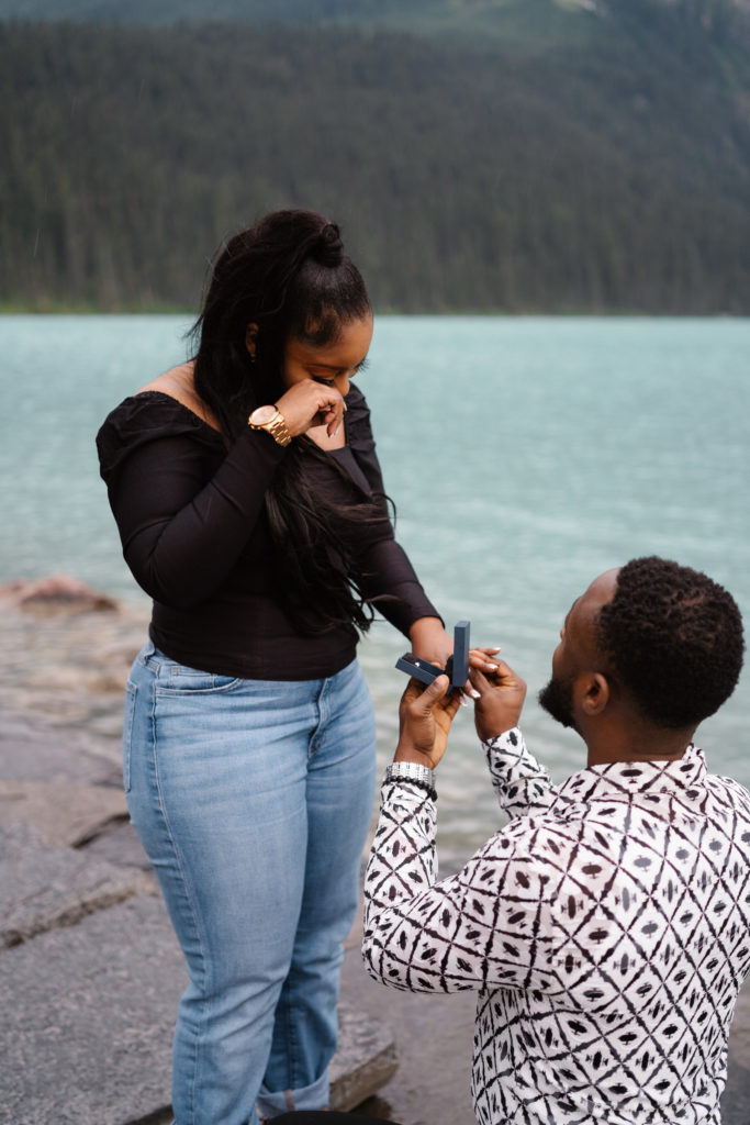 Man slides ring on girlfriends finger in Banff National Park