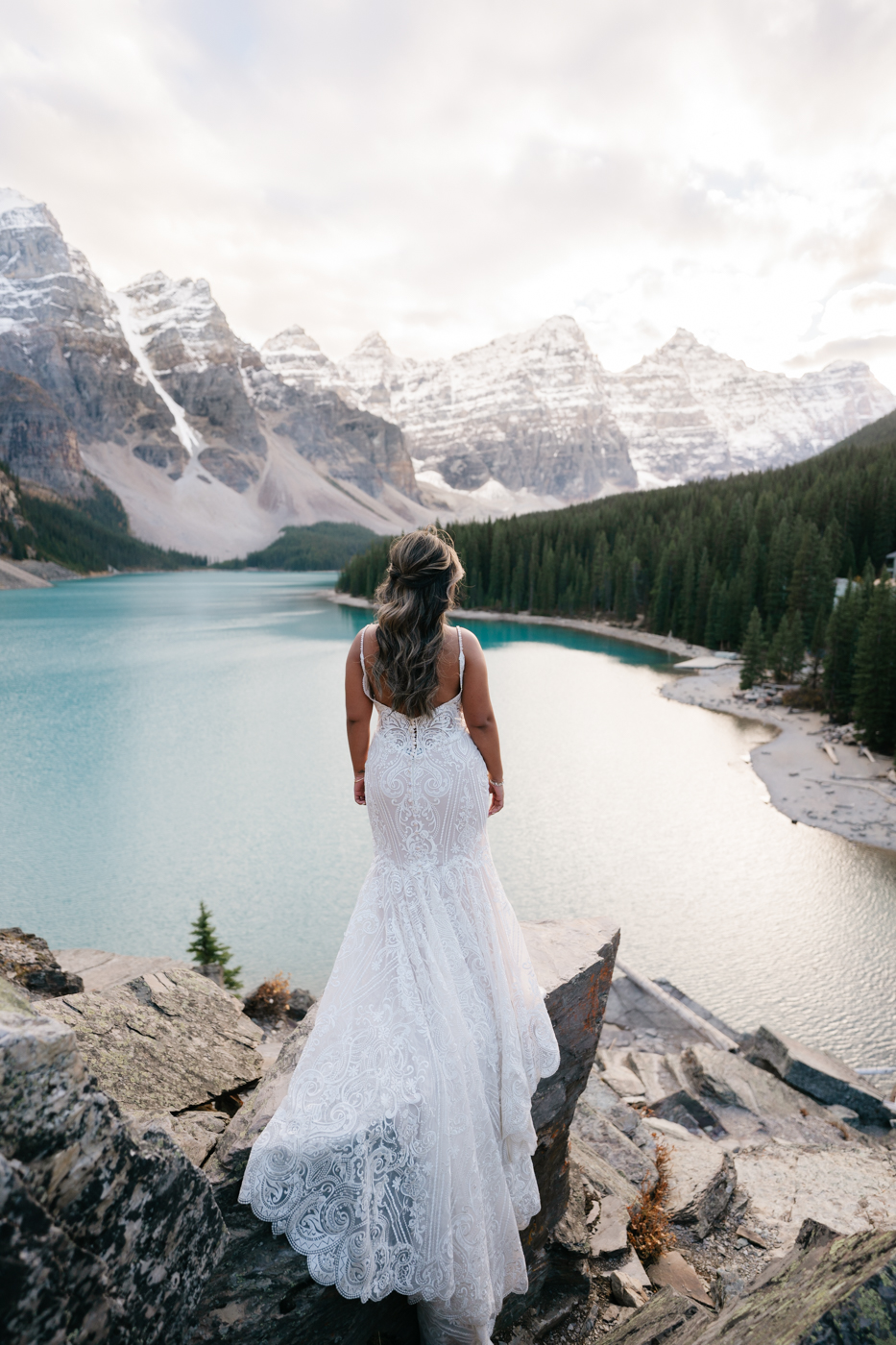Bride faces away from camera and looks out over Moraine Lake