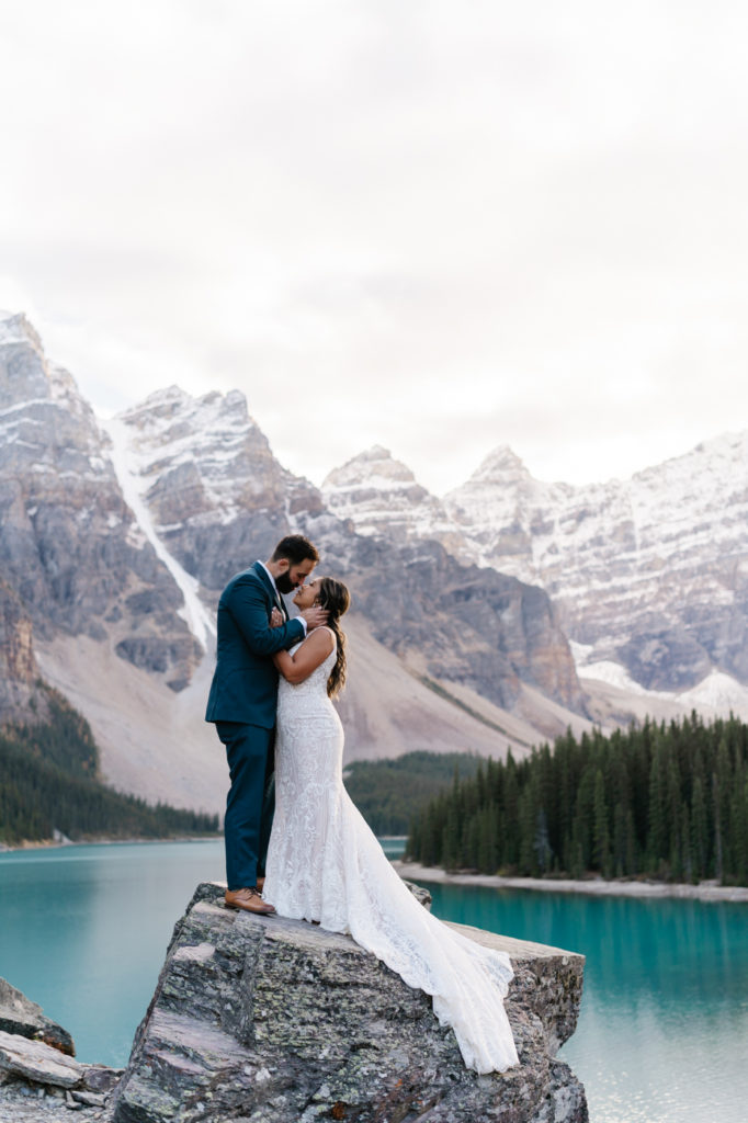Bride and groom kiss in Banff National Park