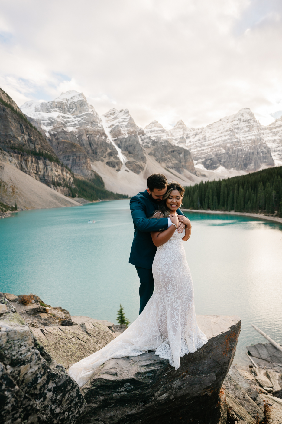 Bride and groom embrace during sunset at Moraine Lake