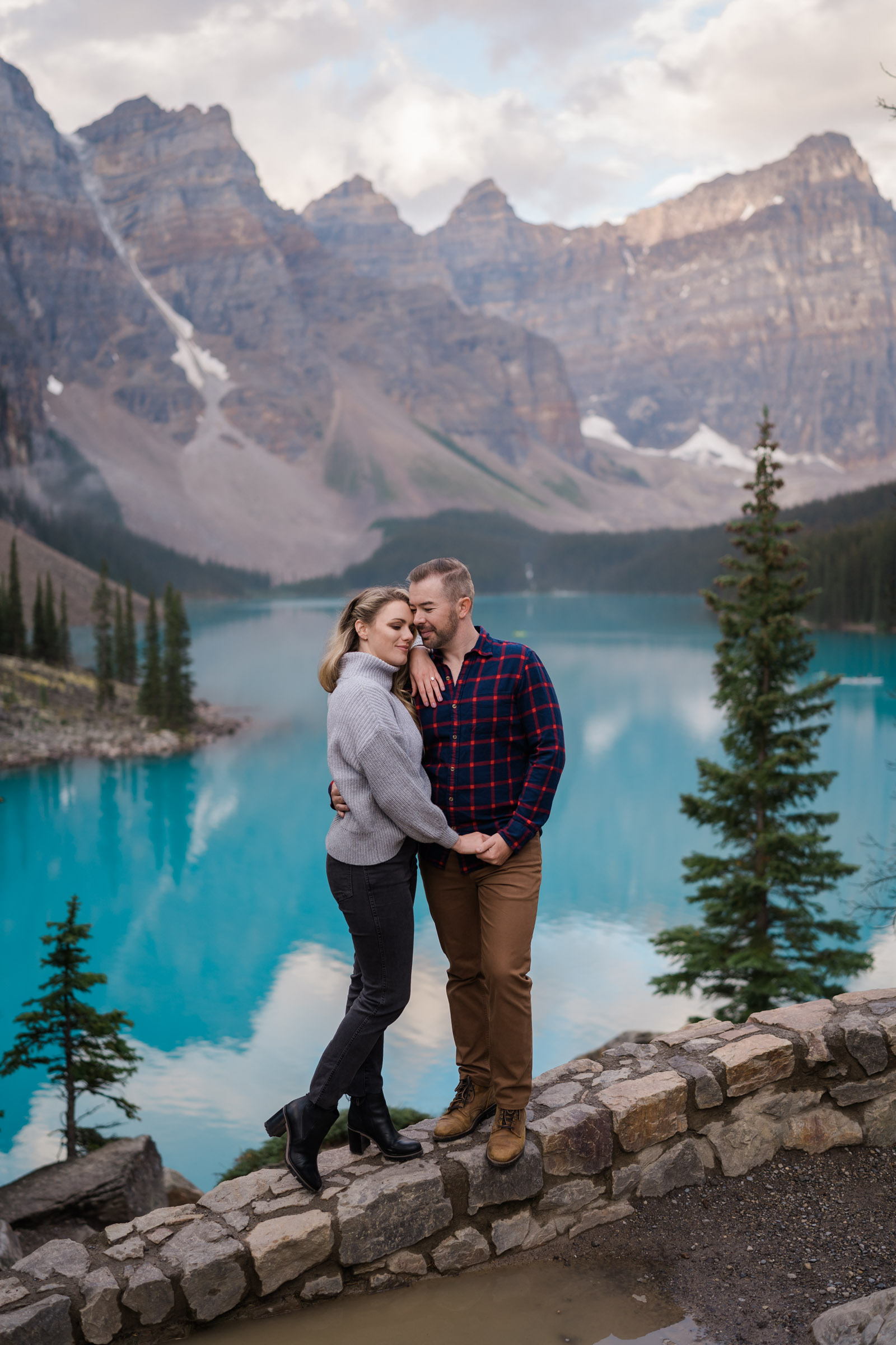 Couple poses on rocks during Banff Engagement Photos. 