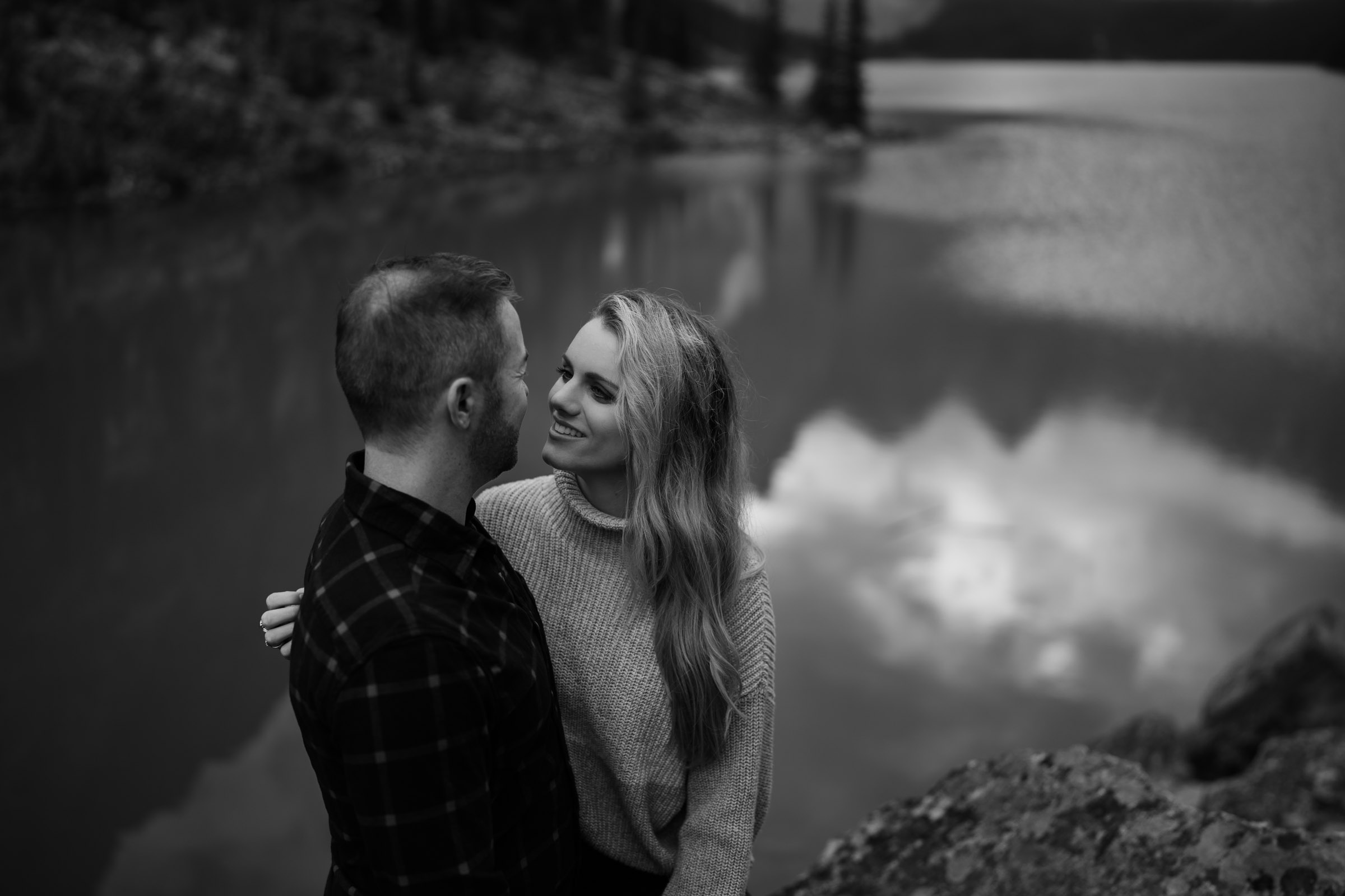 Black and white photo of a couple looking at each other. 