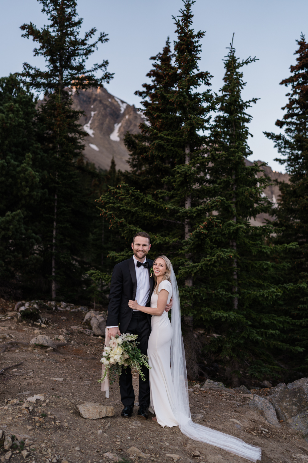 bride and groom stand together and smile at the camera during their Banff sunrise elopement
