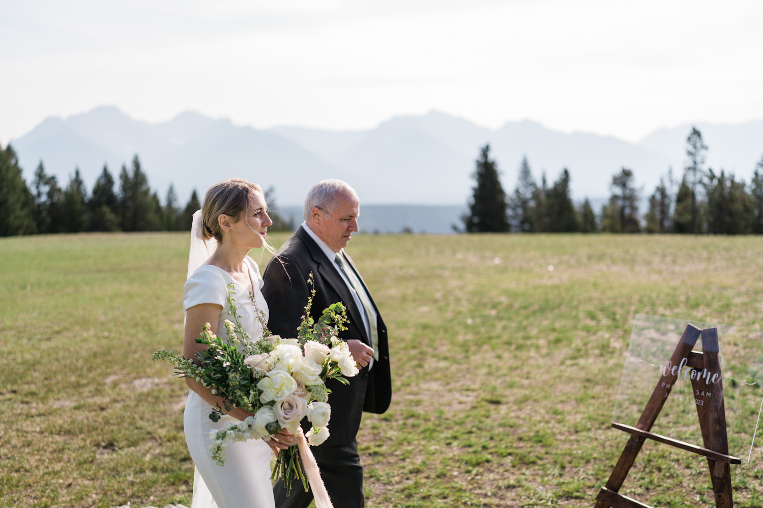 bride walks with her dad down the aisle at Tunnel Mountain in Banff 