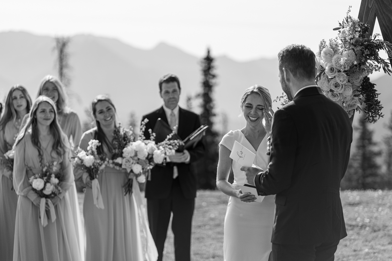 black and white photo of bride wiping her tears while groom reads his vows at Tunnel Mountain in Banff 