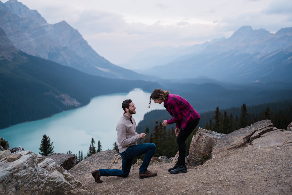 Man on one knee proposed to his girlfriend in front of Peyto Lake in Banff National Park
