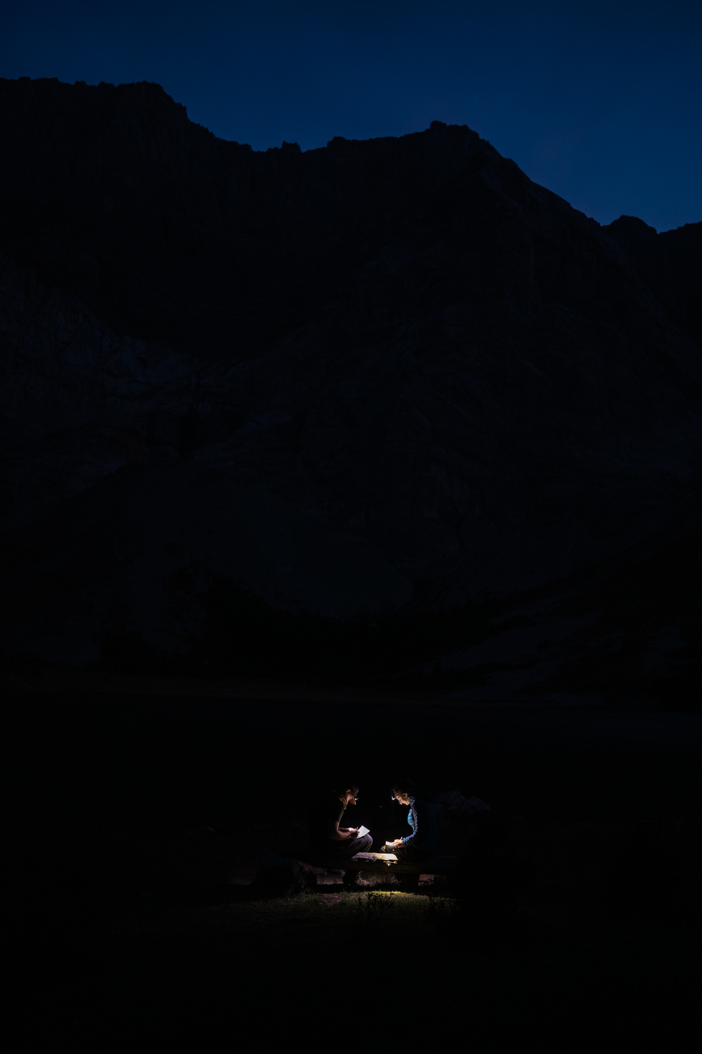 Couple writes vows via headlamp during a Kananaskis camping elopement. 