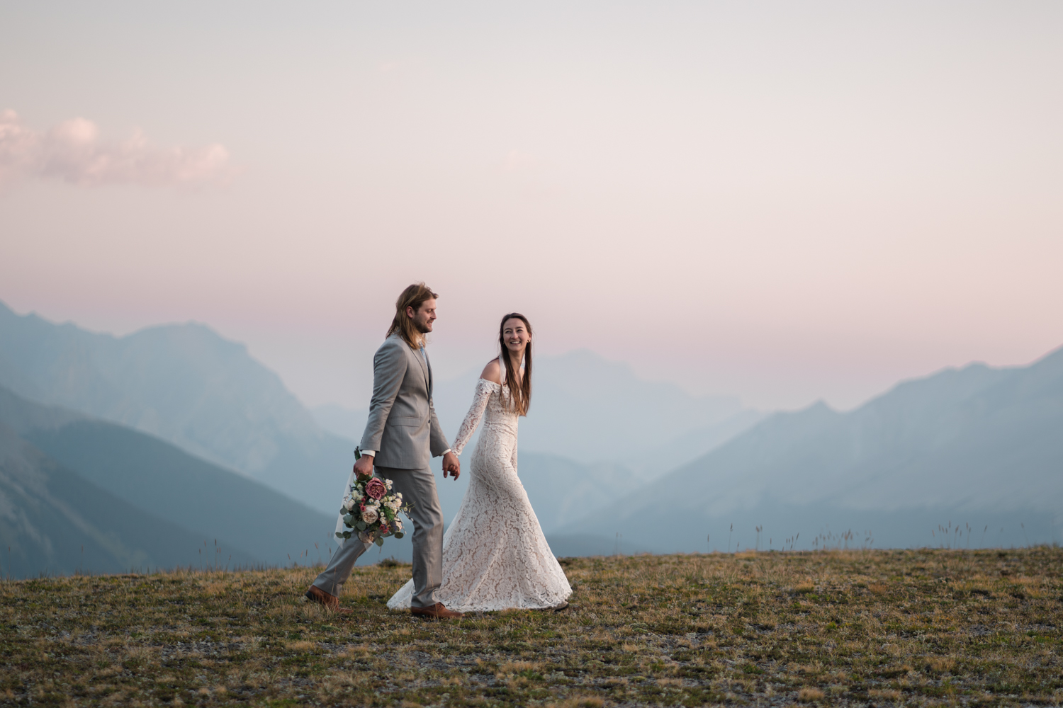 The gentle light of sunrise adding to the romance of a couple's portraits during their backcountry camping elopement in Alberta's Kananaskis