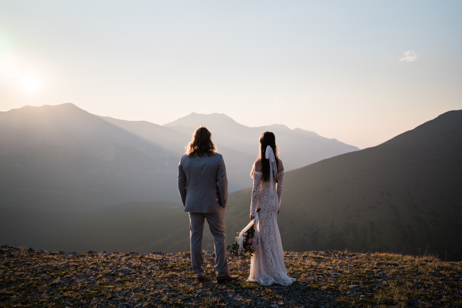 The first light of day kissing the mountains during a serene backcountry camping elopement in Alberta's Kananaskis.