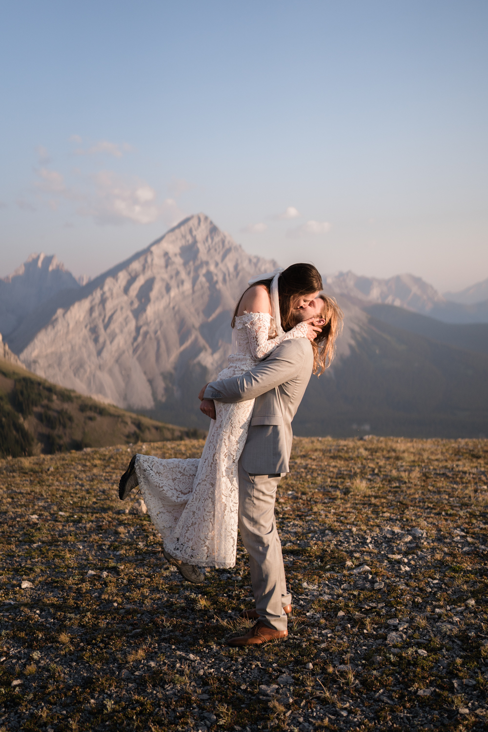 A couple's joyful embrace captured in the stunning landscape of an Alberta elopement in Kananaskis