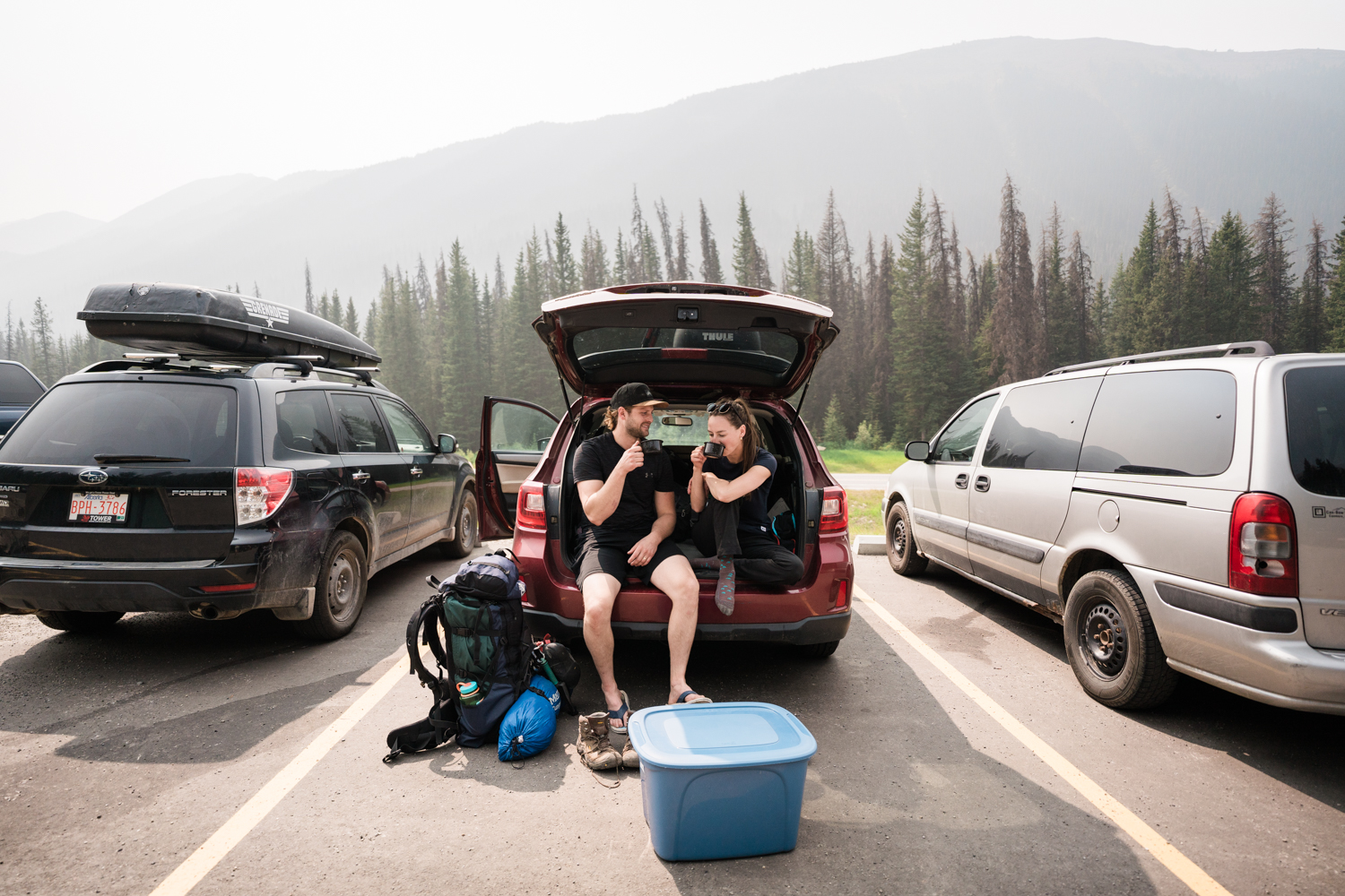Couple sits together in back of car after their Kananaskis camping elopement