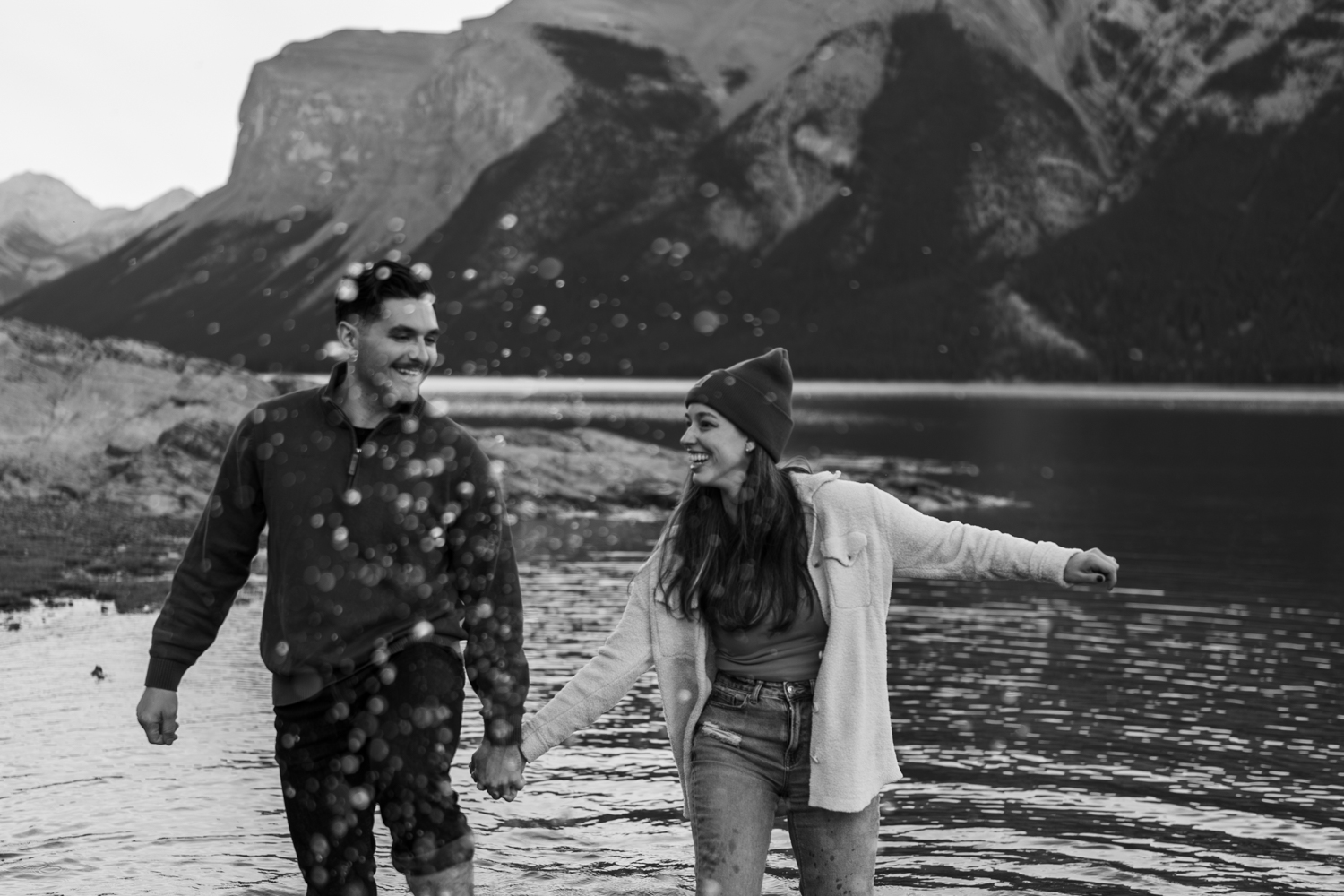 Couple walks and plays in the water after Banff proposal.