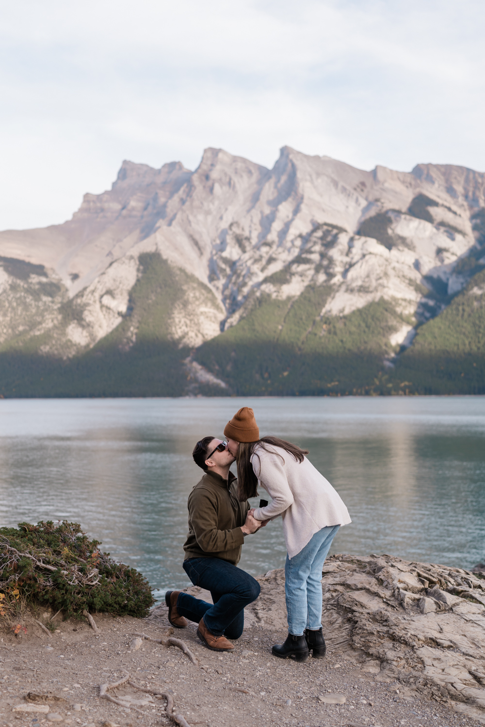 Couple kisses after a surprise Banff proposal. 